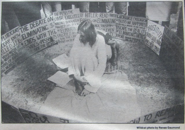 I sewed (by hand) the dress and backpack. Every weekday I made a new sign and demonstrated downtown. (The twin Superior Court Judges Roylston liked me and I made many friends downtown.) One day I collected all my signs and went to the university. My pic was on the front-page of the Daily Wildcat.